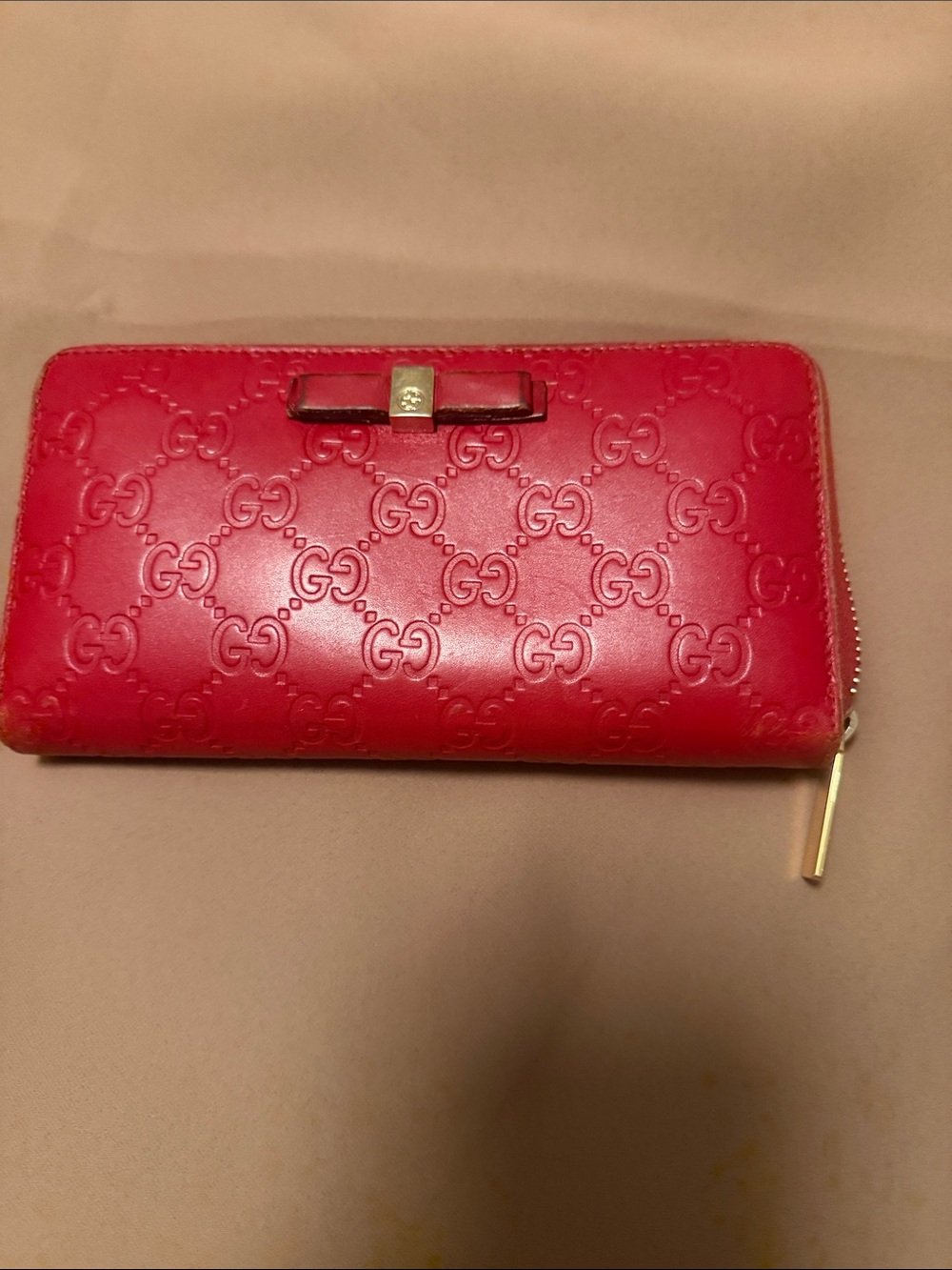 Authentic Gucci Embossed Zip-Around Wallet with Bow Accent
